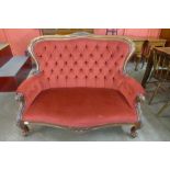 A Victorian carved mahogany and upholstered settee