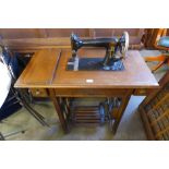 A Victoria oak treadle sewing machine