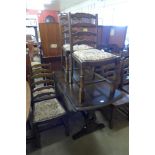 An oak gateleg table and four ladderback chairs