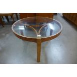 A Nathan teak and glass topped circular coffee table