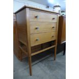 A small teak chest of drawers