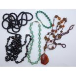 Four necklaces; jet, garnet and amber, one a/f and a malachite bracelet