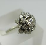 A white metal, diamond set Art Deco ring, with nineteen diamonds in total, the centre stone