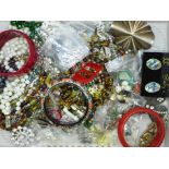 A collection of vintage costume jewellery including bangles, brooches, beaded necklaces, etc.