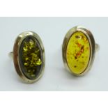 A silver and green amber ring and a silver and amber ring