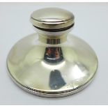 A silver capstan inkwell