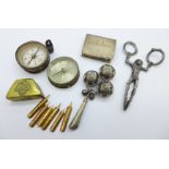A pair of novelty sugar nips, a rattle/whistle, compasses, etc.