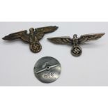 Two reproduction German badges and a badge screw back