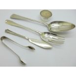 Silver;-Georgian table spoon, salad server, butter knife, sugar bows and candle stand, 204g