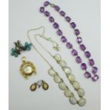 An amethyst necklace and a quartz necklace, a horseshoe pendant watch, a bird brooch and a pair of