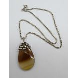 An agate pendant, set in white metal on a modern silver chain, Arts and Crafts in the style of