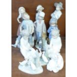 A collection of eleven Nao by Lladro figures, boy sitting a/f
