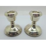 A pair of small silver candlesticks