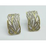 A pair of silver gilt earrings with diamond accents