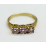 A 9ct gold, three stone amethyst ring, 2g, N