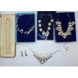 Boxed necklaces and pairs of earrings