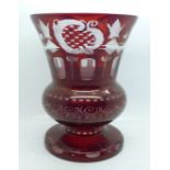 A Bohemian red flash cut glass vase, decorated with a bird, deer, and motifs, 21cm