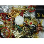 A collection of vintage costume jewellery including brooches, necklaces, etc.
