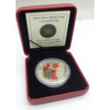 A Royal Canadian Mint 2004 Silver Maple Leaf Coloured Coin, one ounce fine silver, with box