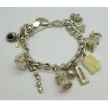 A silver charm bracelet with twelve charms, 40g, (one charm not silver)
