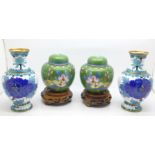 A pair of cloisonne vases and a pair of cloisonne ginger jars on wooden bases