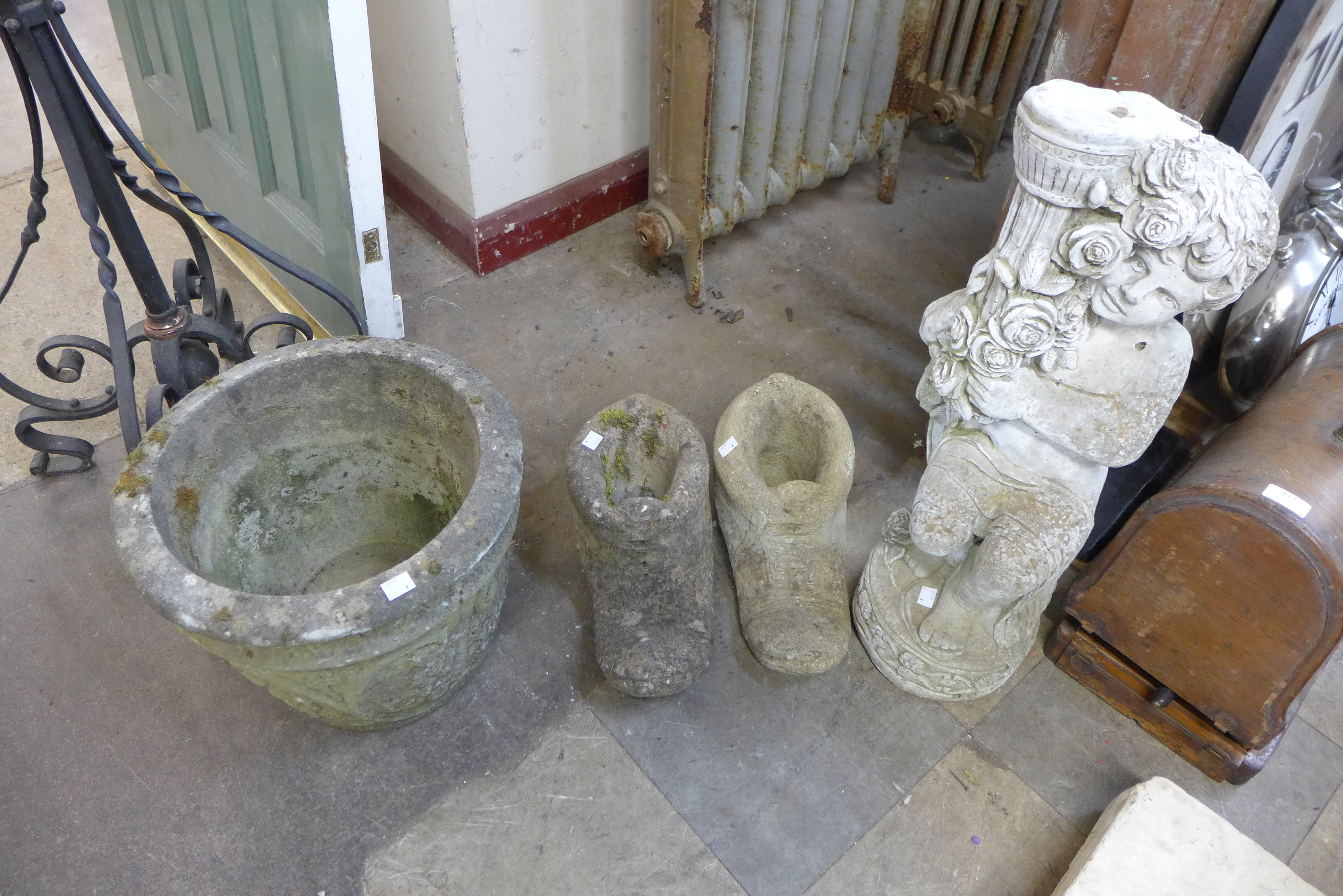 A pair of concrete boot shaped planters, another planter and a cherub water feature, a/f