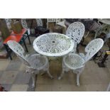 A cast alloy garden table and three chairs