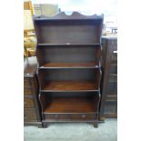 A mahogany open waterfall front bookcase