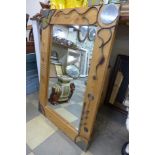 A pine and metalwork framed mirror