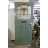 A painted pine and stained glass door