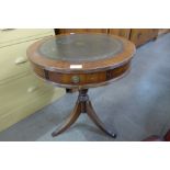 A mahogany and green leather topped drum shaped occasional table