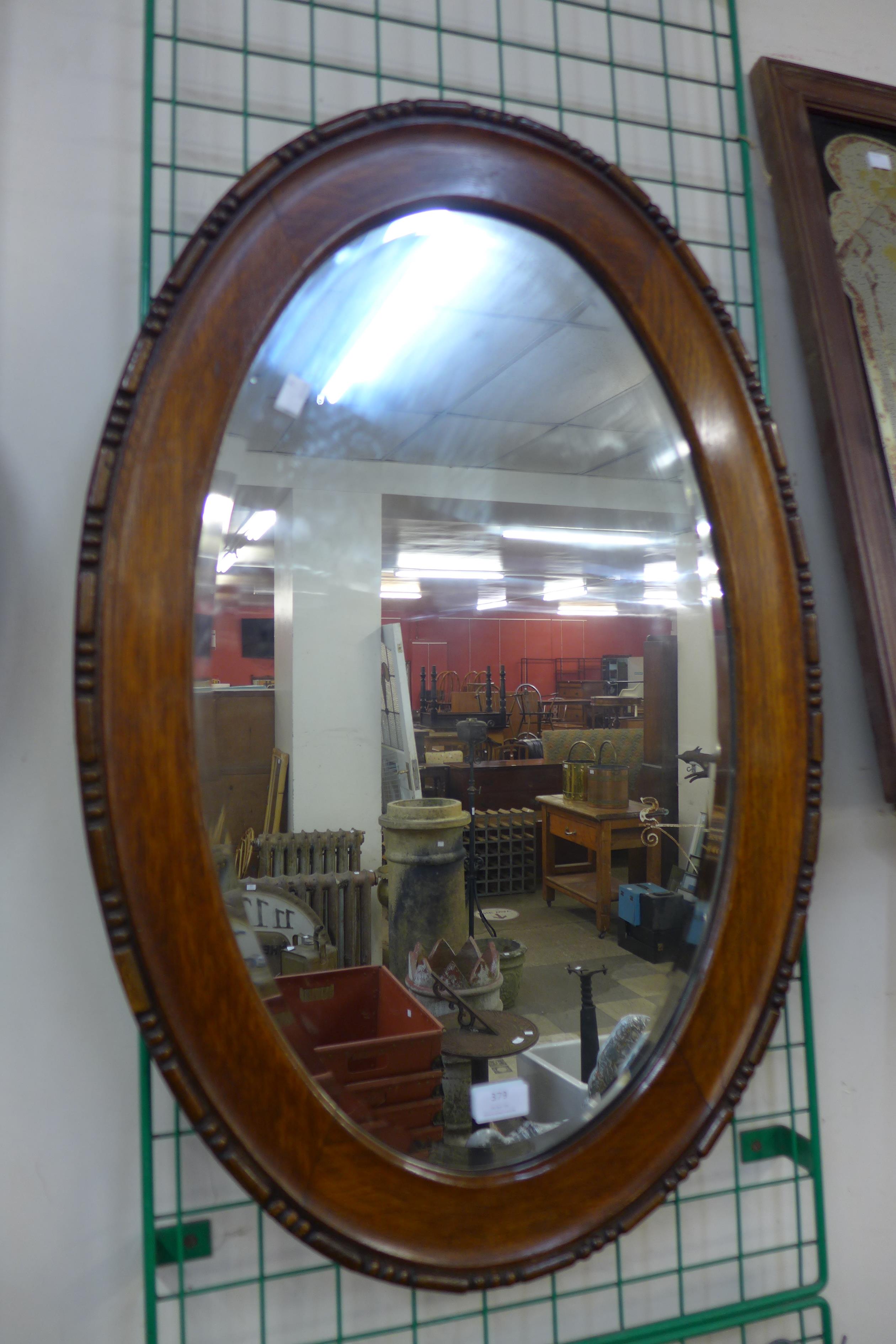 An oak oval framed mirror