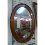 An oak oval framed mirror