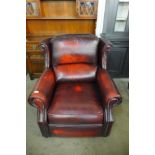 A Thomas Lloyd red leather armchair