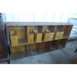 An oak office pigeon hole cabinet with seven filing trays