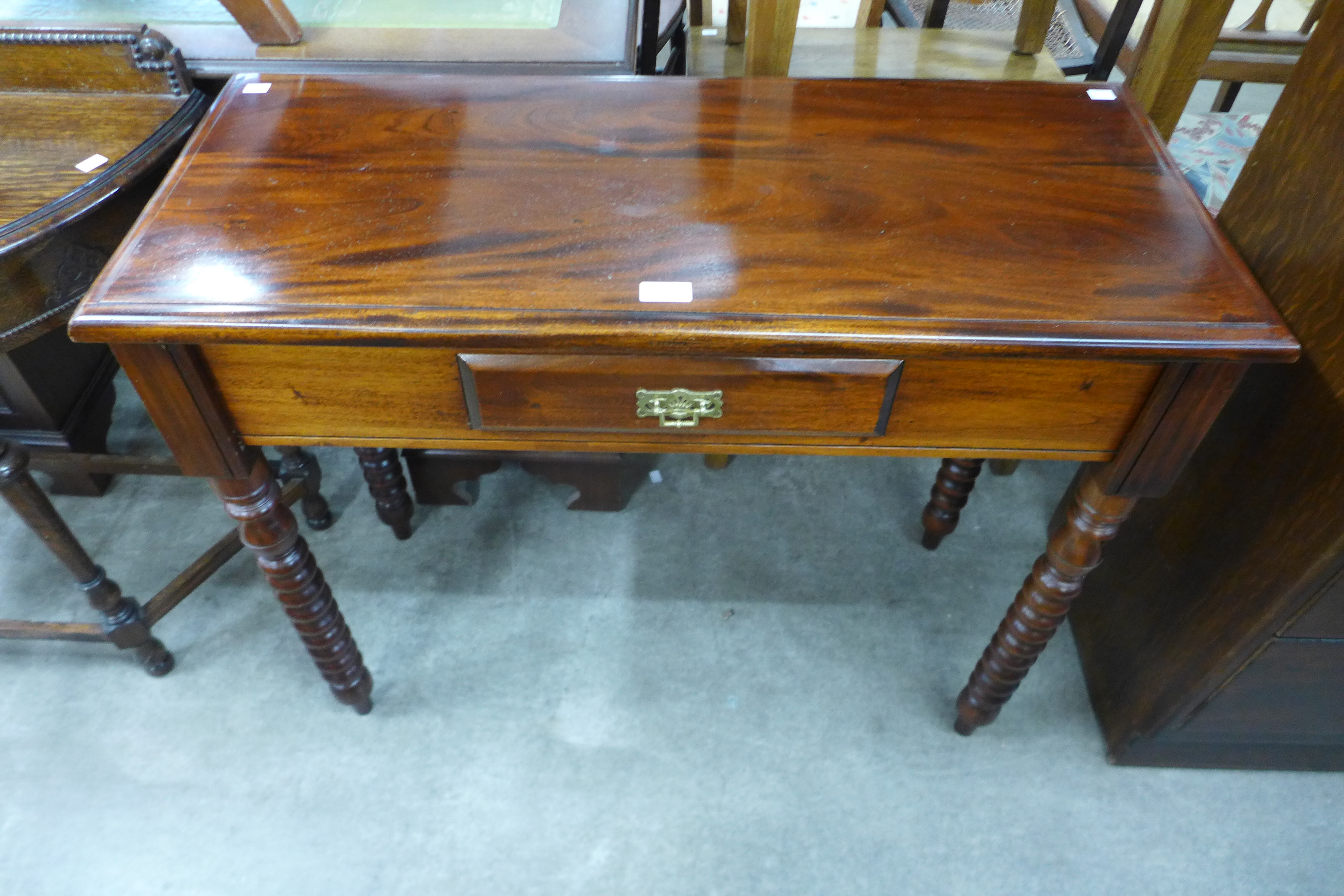 A Victorian style mahogany single drawer side table