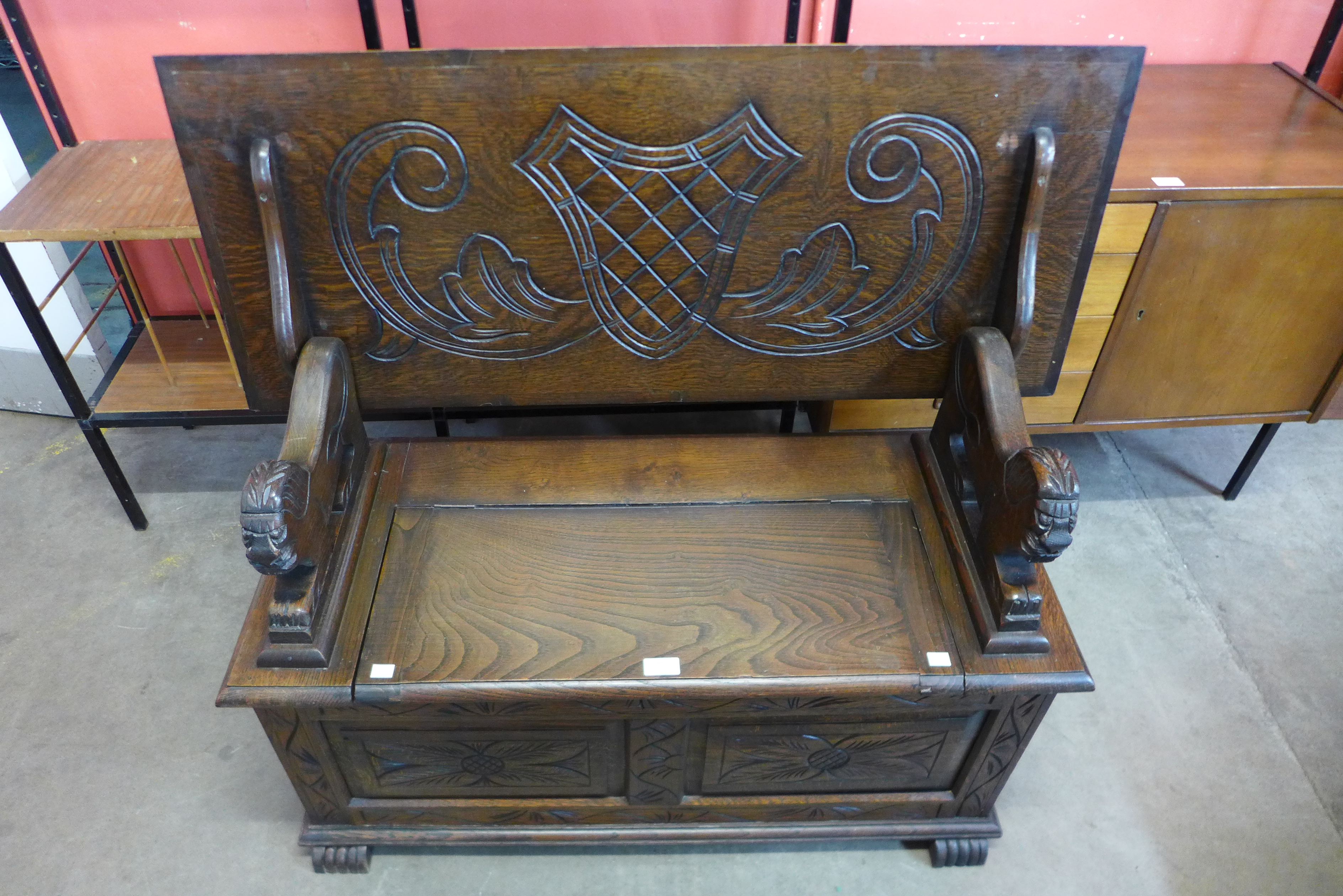 A carved oak monks bench