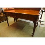 A Victorian mahogany three drawer writing table