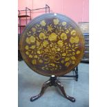 A George III mahogany and marquetry inlaid circular tilt top center table