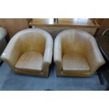 A pair of caramel leather tub chairs