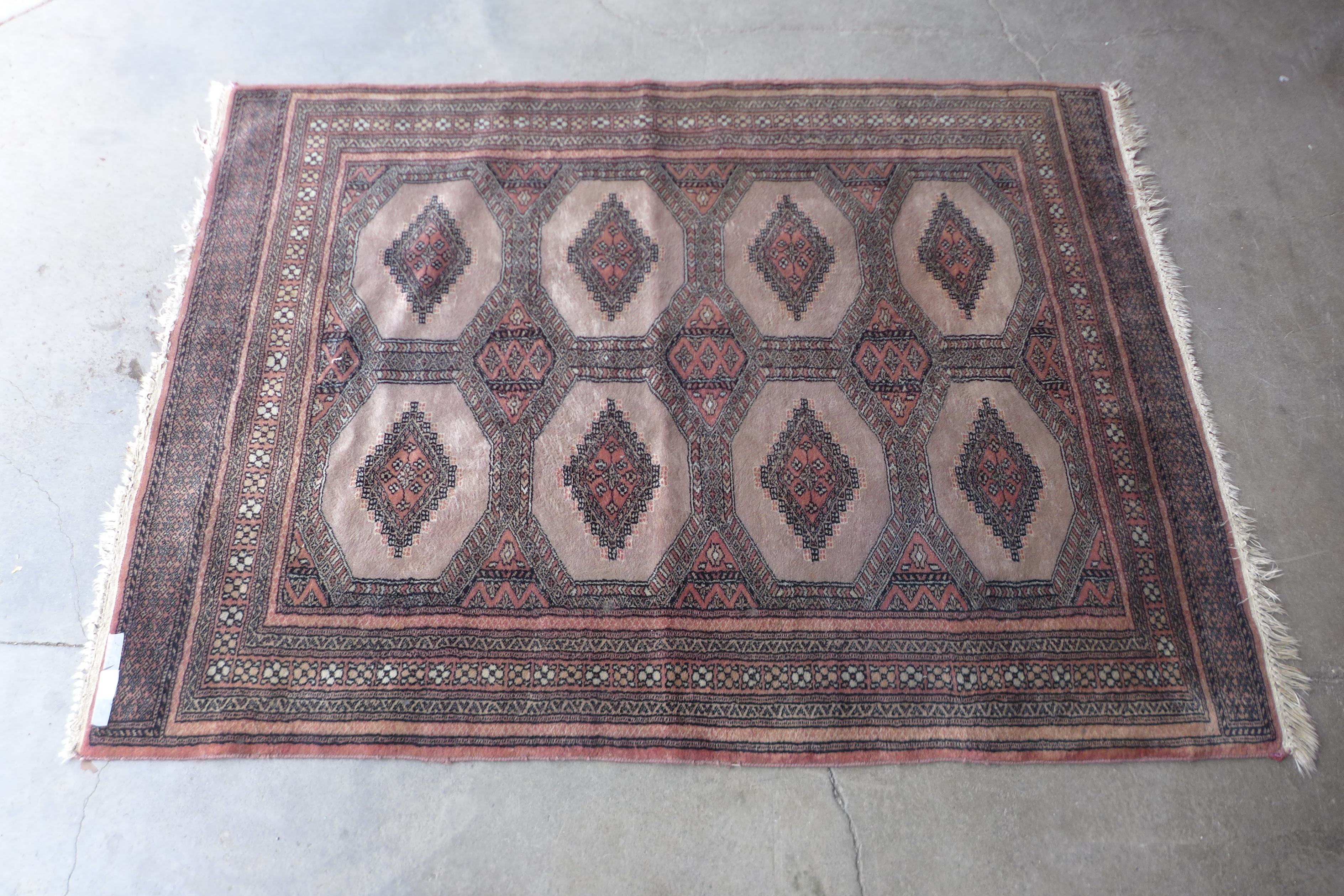 An eastern terracotta ground rug, 174 x 126cms