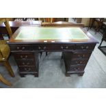 A mahogany and green leather topped pedestal desk