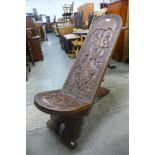 An African carved softwood birthing chair