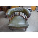 An early Victorian mahogany and green faux leather tub shaped library chair