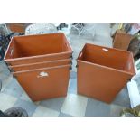 A set of four large stacking factory bins