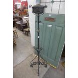 An Art Nouveau wrought iron and copper floor standing oil lamp