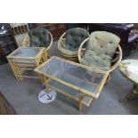A set of three bamboo swivel chairs by Angraves Invincible, Thurmaston, Leicester, a coffee table