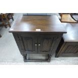 A small Old Charm oak two door cabinet