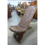 An African carved softwood birthing chair