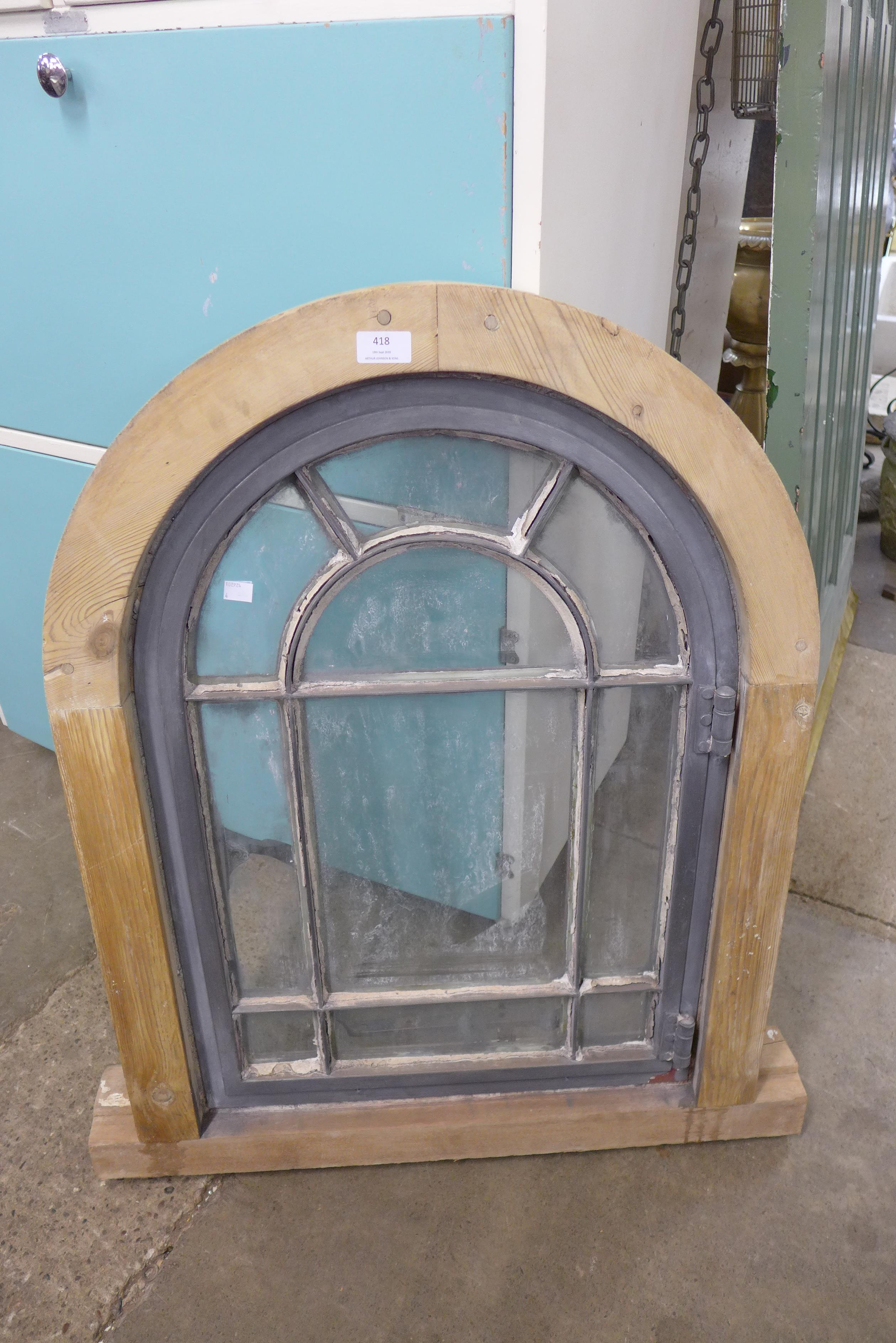 An arched pine framed window